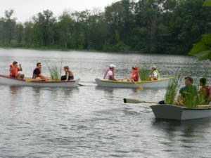 Students transporting plants by canoe