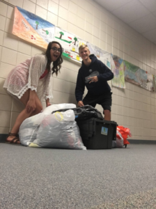 students with bags of clothes