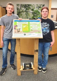 Students standing by project board